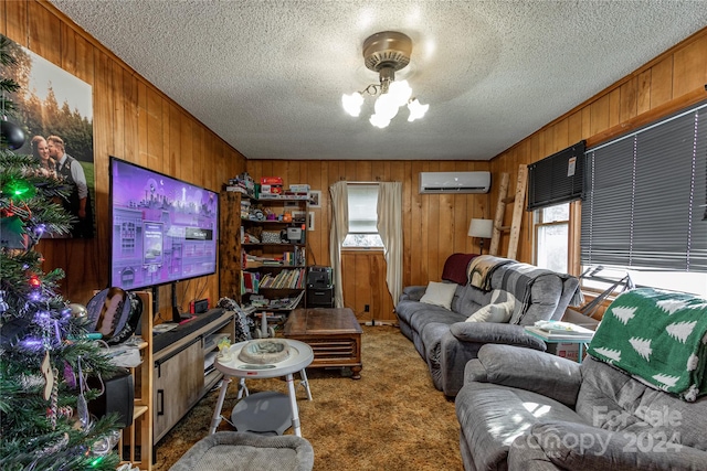 carpeted living room with a wall unit AC, wood walls, a healthy amount of sunlight, and a textured ceiling