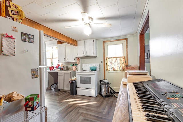 kitchen with white cabinets, dark parquet floors, ceiling fan, and white appliances