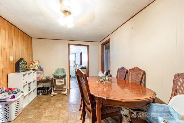 dining area featuring wood walls