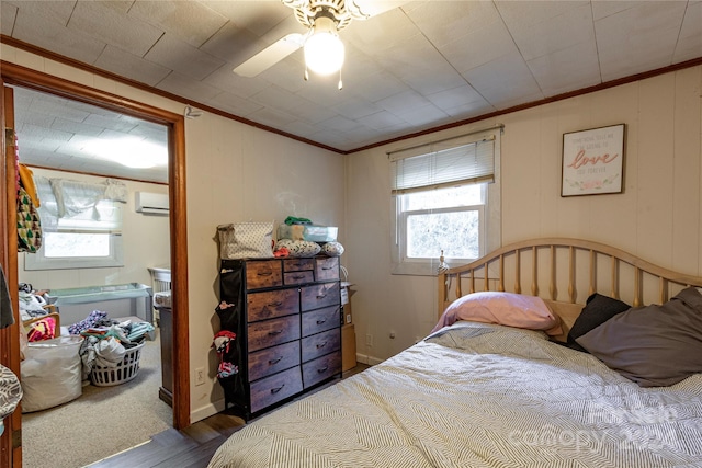 bedroom featuring ceiling fan, crown molding, a wall mounted AC, and dark hardwood / wood-style flooring