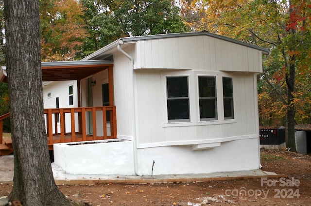 view of property exterior with a deck