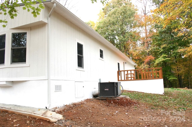 view of property exterior featuring central AC and a wooden deck