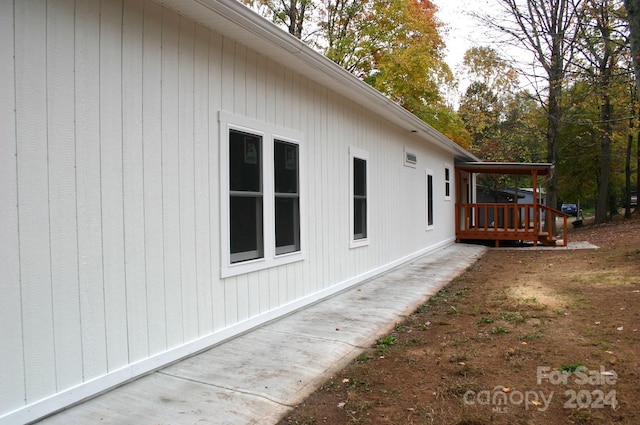 view of side of home featuring a wooden deck