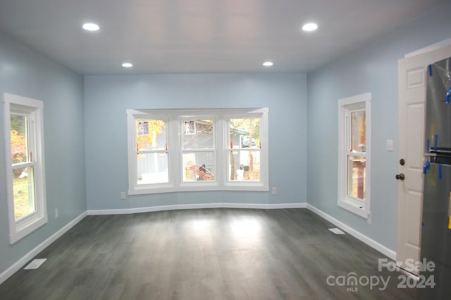 spare room featuring dark hardwood / wood-style flooring