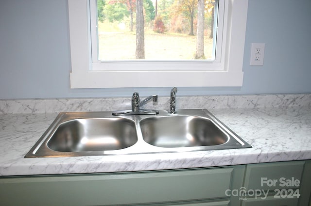 details with green cabinets and sink