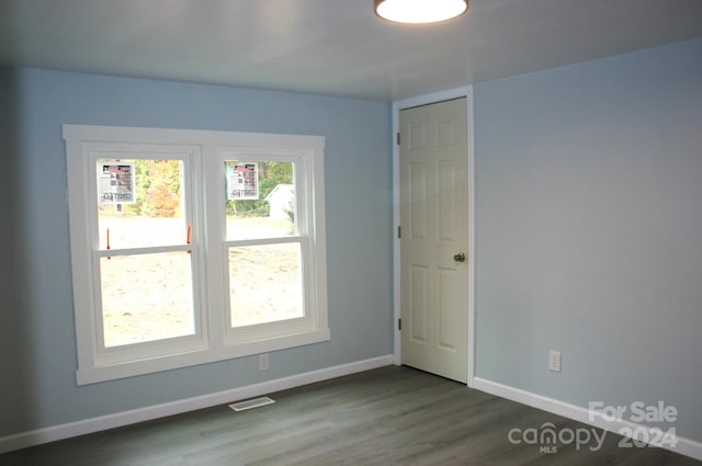 spare room featuring dark hardwood / wood-style floors