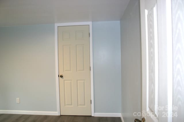 unfurnished room featuring dark hardwood / wood-style floors