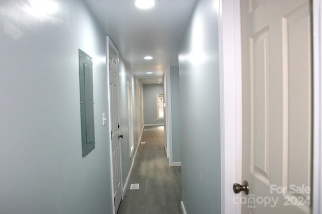 hallway featuring dark wood-type flooring and electric panel