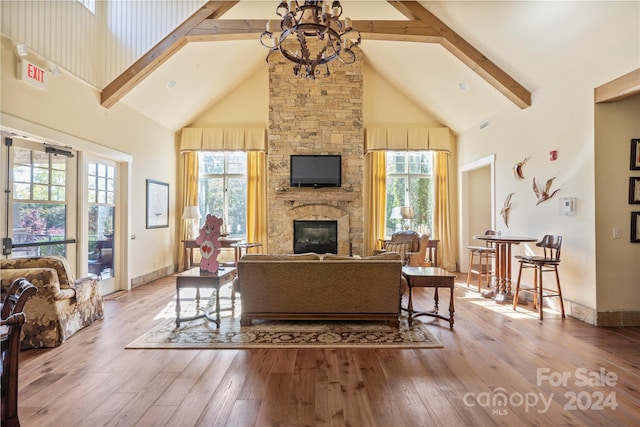 living room with high vaulted ceiling, light hardwood / wood-style flooring, and plenty of natural light