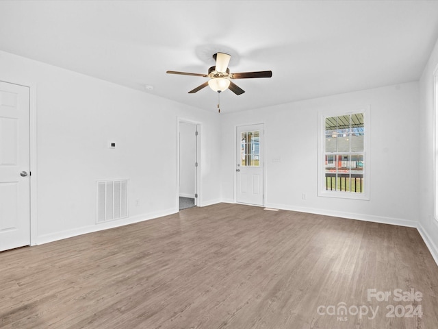 empty room with hardwood / wood-style floors and ceiling fan