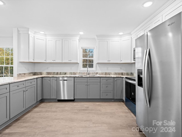 kitchen featuring gray cabinets, sink, white cabinetry, and stainless steel appliances