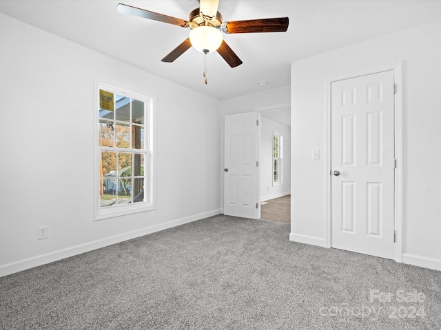 unfurnished room with carpet and ceiling fan