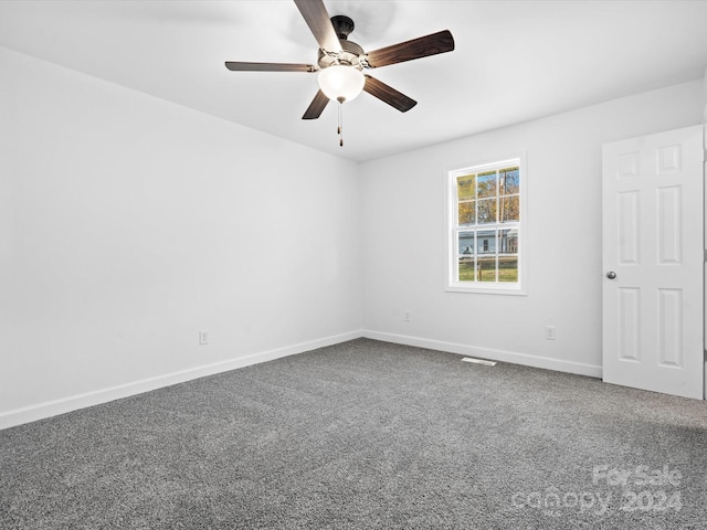 empty room featuring ceiling fan and carpet floors