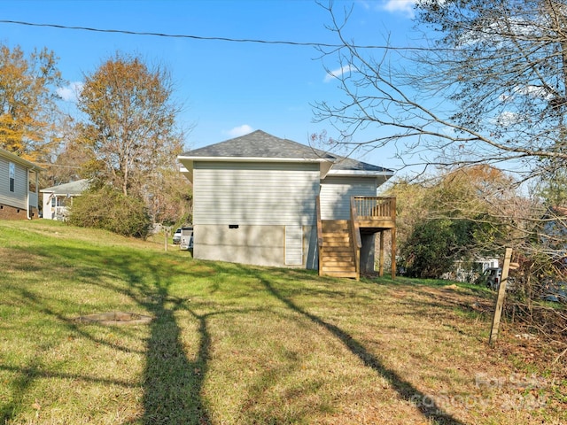 rear view of house featuring a lawn and a wooden deck