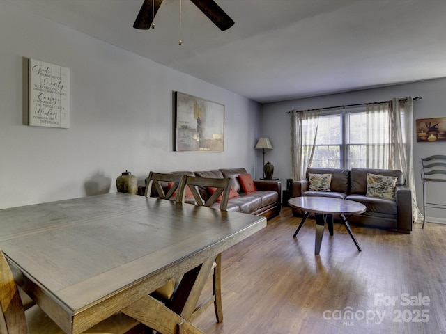 dining area with hardwood / wood-style floors and ceiling fan