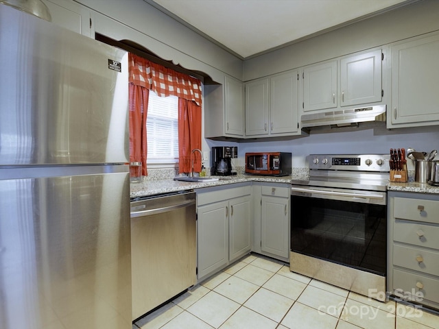 kitchen with gray cabinetry, sink, light tile patterned floors, and appliances with stainless steel finishes