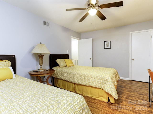 bedroom featuring dark wood-type flooring and ceiling fan