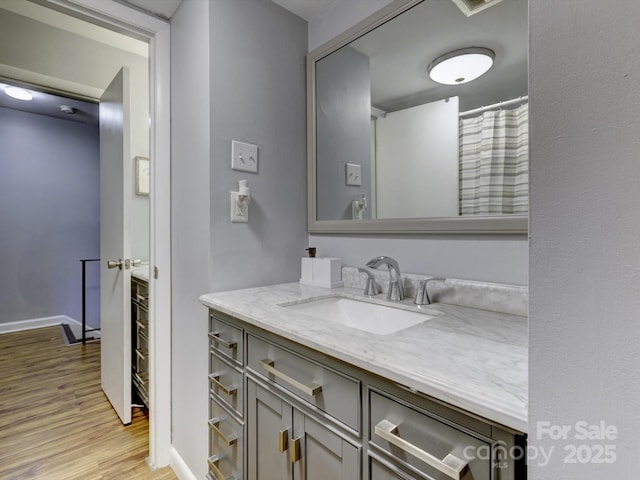 bathroom with vanity and hardwood / wood-style floors