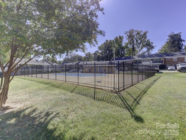 view of pool with a lawn