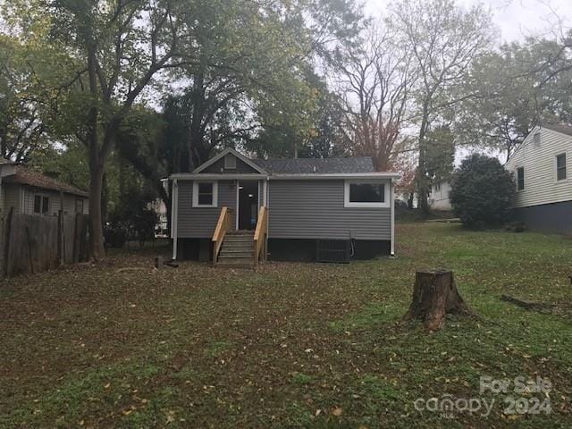 bungalow featuring central air condition unit and fence