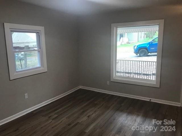 unfurnished room featuring dark wood-type flooring