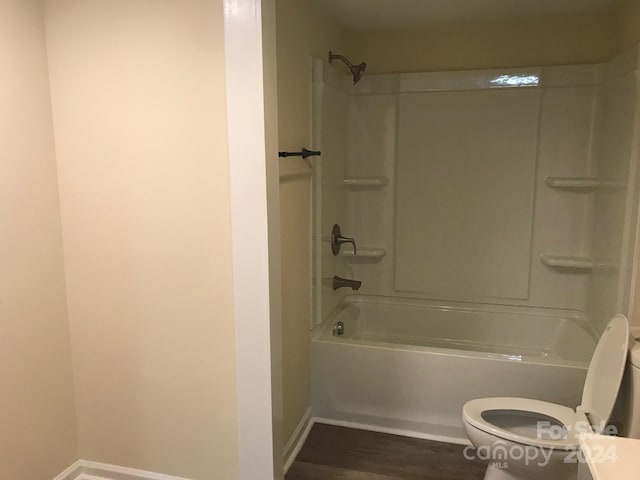 full bathroom featuring hardwood / wood-style floors, vanity, toilet, and bathing tub / shower combination