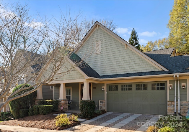 craftsman inspired home with a porch and a garage