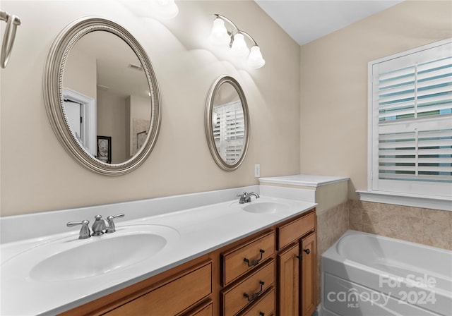 bathroom featuring vanity and a bathtub