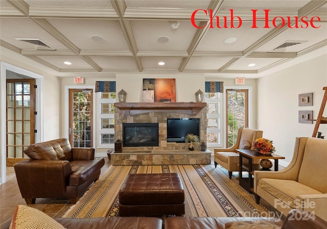 living room featuring plenty of natural light, crown molding, a fireplace, and coffered ceiling