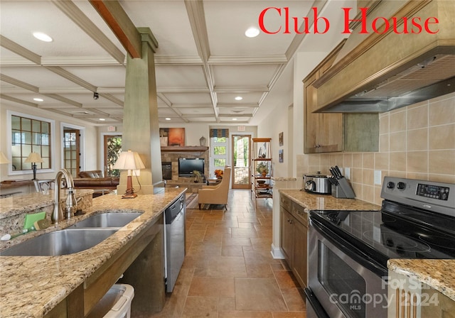 kitchen featuring appliances with stainless steel finishes, light stone counters, custom exhaust hood, sink, and beam ceiling