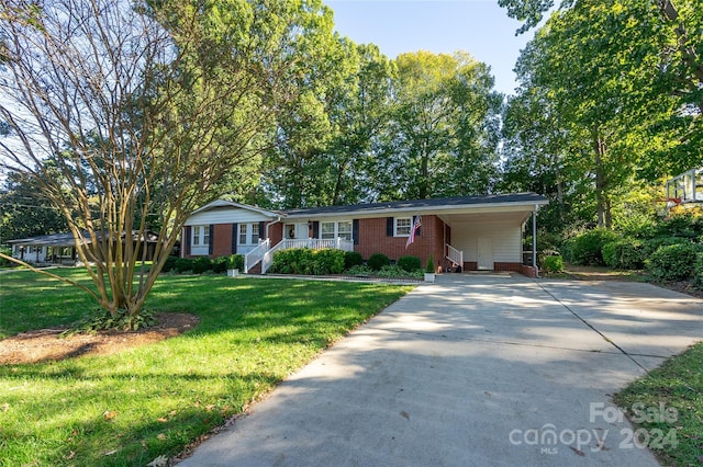 ranch-style home with a carport and a front yard