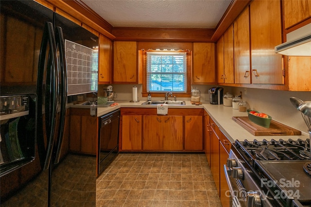 kitchen featuring ventilation hood, a textured ceiling, sink, and black appliances