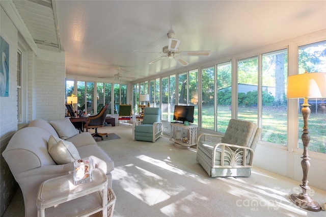 sunroom featuring a healthy amount of sunlight and ceiling fan