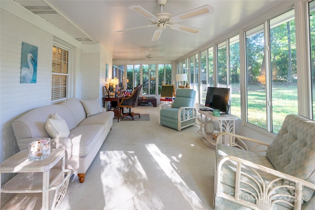 sunroom / solarium featuring a wealth of natural light and ceiling fan