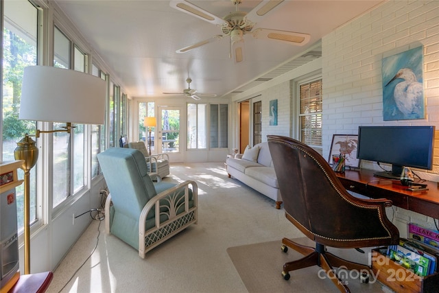 carpeted office space featuring a healthy amount of sunlight and ceiling fan