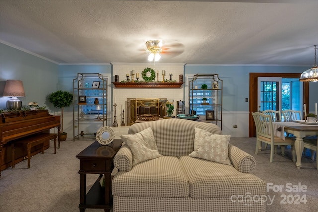 living room with carpet flooring, a brick fireplace, a textured ceiling, and crown molding