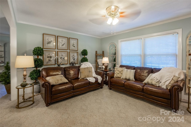 carpeted living room featuring ceiling fan and ornamental molding