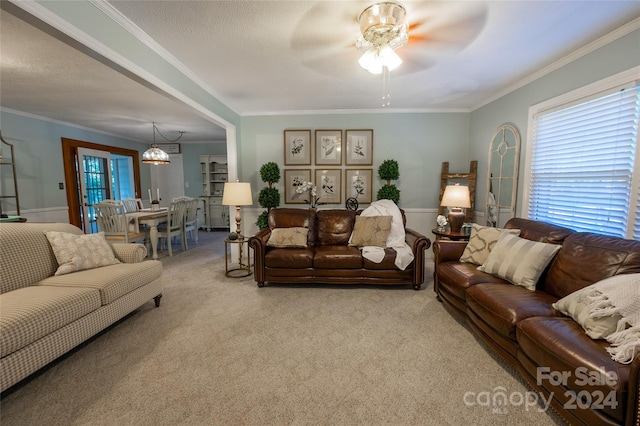 carpeted living room featuring ornamental molding, ceiling fan with notable chandelier, and a textured ceiling