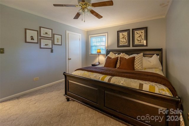 carpeted bedroom featuring ceiling fan and crown molding