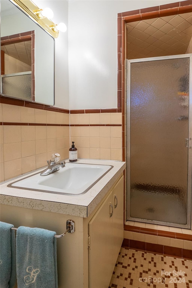 bathroom featuring walk in shower, sink, and tile patterned flooring