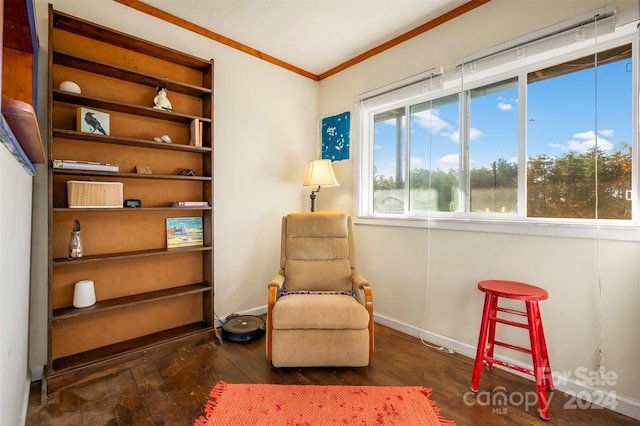 living area featuring ornamental molding and dark hardwood / wood-style flooring