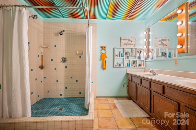 bathroom featuring vanity, tile patterned floors, and walk in shower