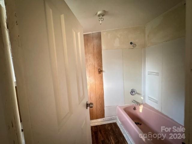 bathroom with hardwood / wood-style floors and shower / bath combination