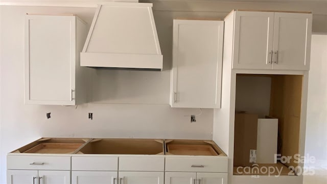 kitchen featuring premium range hood and white cabinetry