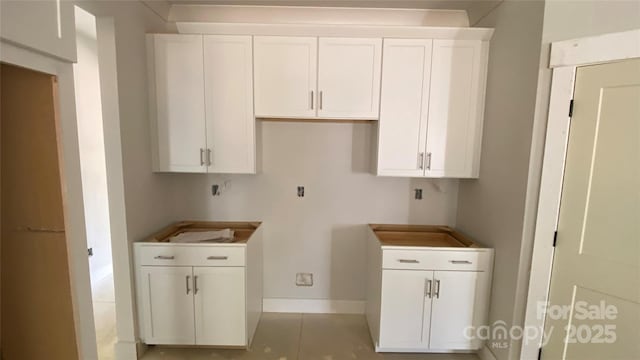 laundry room featuring baseboards