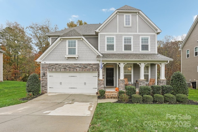 view of front facade with a garage, a front lawn, and a porch