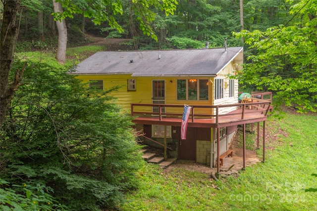 back of property with a wooden deck