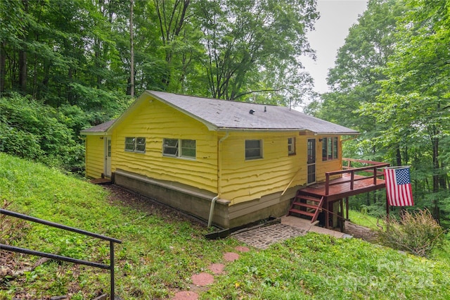 rear view of house with a wooden deck