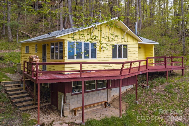 rear view of house featuring a deck