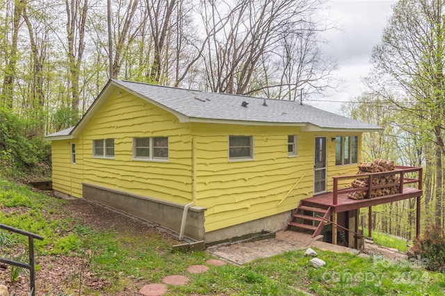 view of side of home featuring a wooden deck